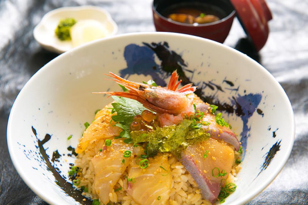 A seafood bowl featuring fresh fish pieces marinated in special sauce.